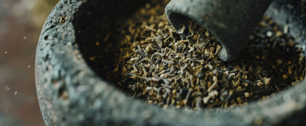 a detailed shot of a mortar and pestle crushing dried herbs into a fine powder releasing a soothing aroma